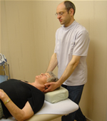 Manipulating the spine of a patient to alleviate neck pain at one of the osteopath clinics